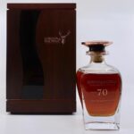 This exquisite GlenGrant 70-year-old single malt Scotch whisky from Gordon & MacPhail is elegantly encased in a wooden presentation box, making it a premium investment for serious whisky collectors.