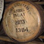 A wooden barrel stamped "Ardbeg Distillery Ltd Islay 2003 1304" offers a glimpse into premium cask whisky, ideal for whisky enthusiasts and collectors seeking a high-value vintage investment from 2003.