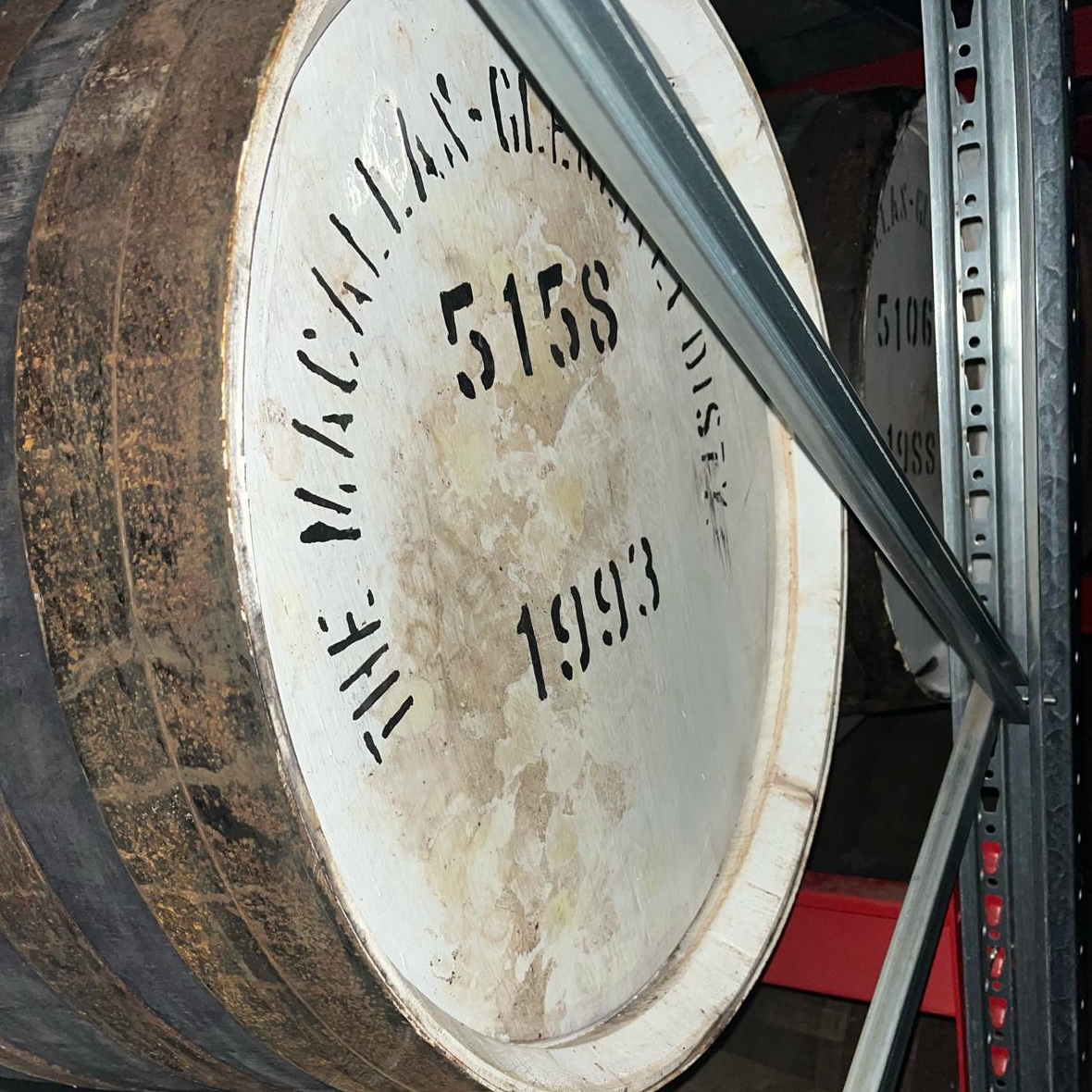 Close-up of a premium The Macallan Glenlivet whisky barrel, vintage 1993, on a metal rack—ideal for whisky investment visuals.