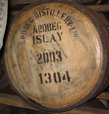 A wooden barrel stamped "Ardbeg Distillery Ltd Islay 2003 1304" offers a glimpse into premium cask whisky, ideal for whisky enthusiasts and collectors seeking a high-value vintage investment from 2003.